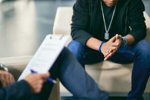 behavioral health specialist discussing marijuana addiction treatment with client in an office setting.