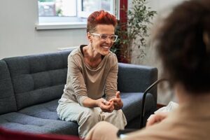 middle-aged woman discussing with her addiciton treatment specialist the advantages of vivitrol treatment in a professional office setting