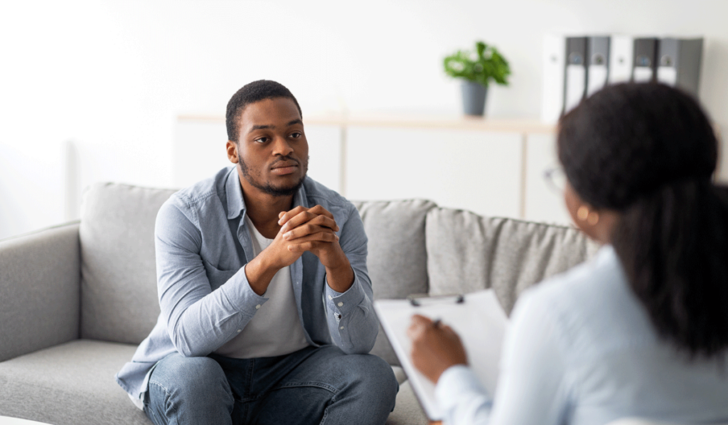 young man discussing the benefits of Vivitrol treatment with female therapist