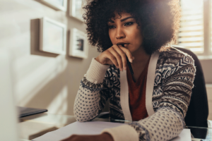 young woman looking introspective and thoughtful as she contemplates ways of recognizing relapse triggers